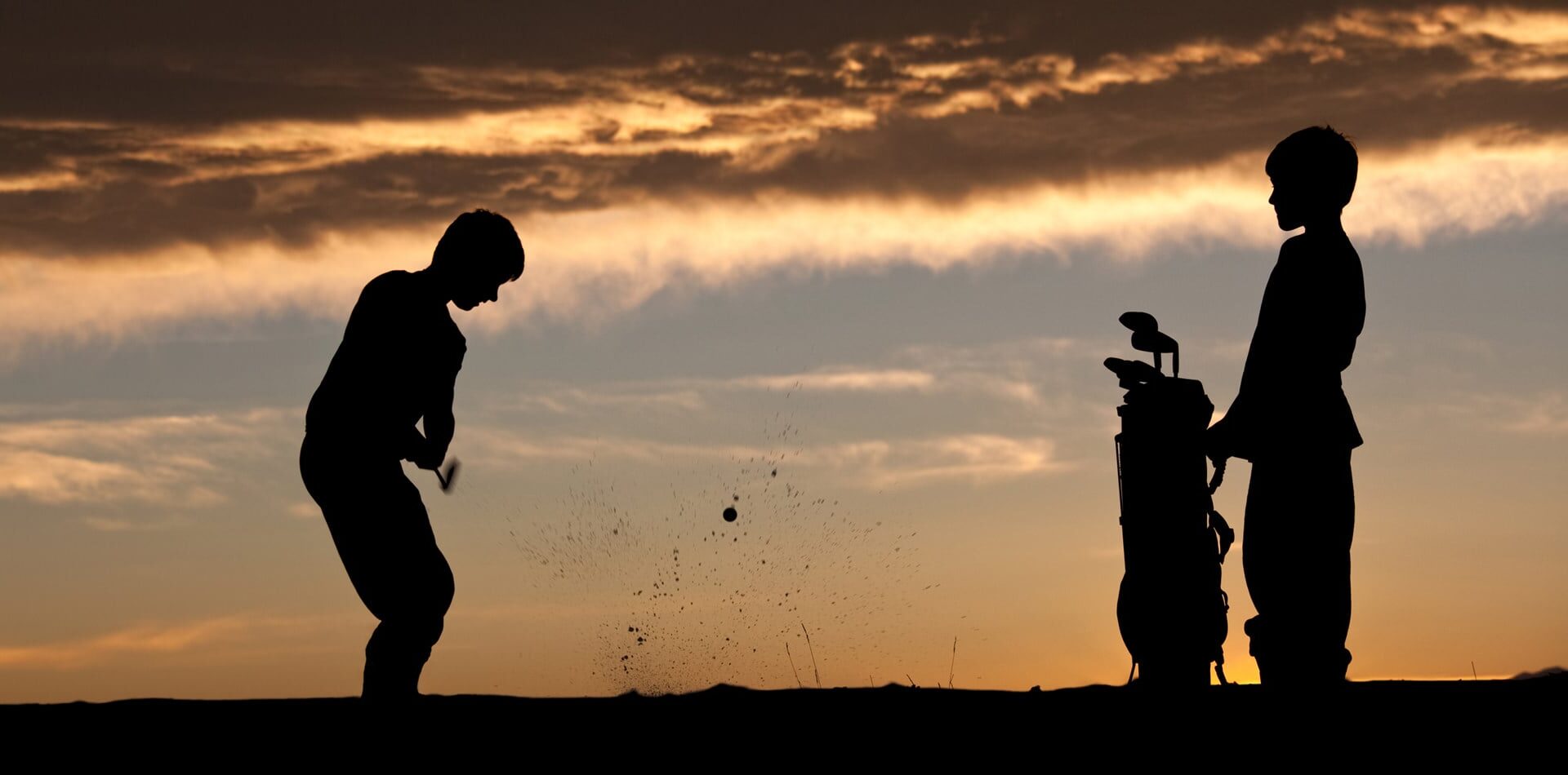 Silhouette of junior golfers