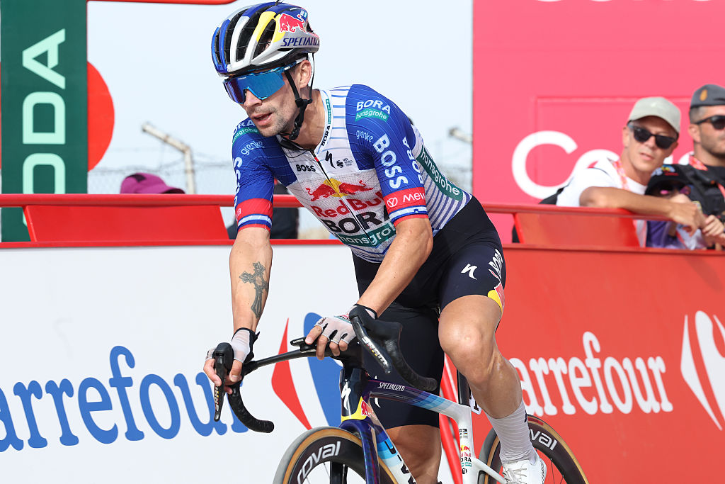Primoz Roglic of Red Bull - BORA - hansgrohe crosses the finish line of stage 14 a few positions behind race leader Mas, and moves to third in GC