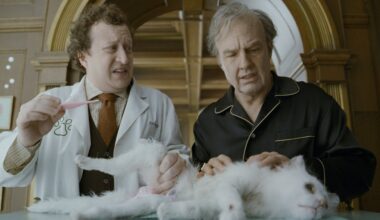 DIGGER, from left: Ross Hatt, Tom Cruise, with Maggie the cat, 2026. © Warner Bros. /Courtesy Everett Collection