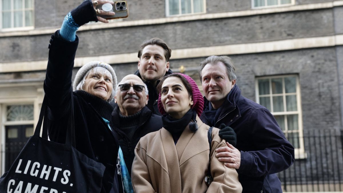 (L-R) Sue Clark, Anoosheh Ashoori, Joe Bennett, Leila Ashoori, and Richard Ratcliffe, family and supporters of Lindsay and Craig Foreman, a couple detained in Iran without charge pose for a selfie photogragh in Downing Street during a day of action in London on January 3, 2026, to raise national awareness of the couple's ongoing detention and the need for urgent intervention. A British couple, Lindsay and Craig Foreman, both in their early fifties, were seized in January 2025, as they passed through Kerman, in central Iran, while on a round-the-world motorbike trip. Iran accuses the couple of entering the country pretending to be tourists so as to gather information for foreign intelligence services, an allegation the couple's family rejects. (Photo by Brook Mitchell / AFP via Getty Images)