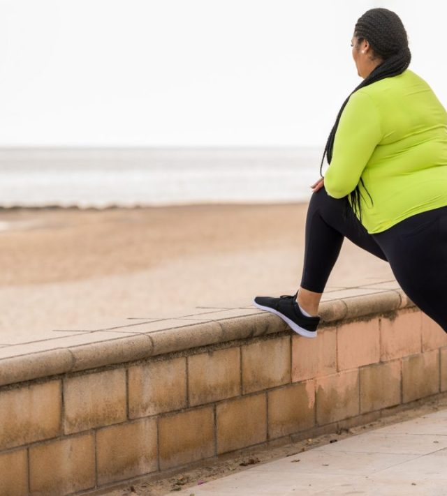 Obesity woman stretching before daily outdoor training