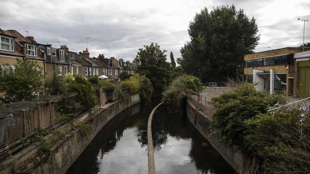 LONDON, ENGLAND - AUGUST 26: The river Wandle runs past houses in Wandsworth on August 24, 2020 in London, England. The river Wandle is a tributary of the river Thames running north for around 14 km through Croydon, Sutton, Merton before meeting the Thames in Wandsworth. The river was heavily industrialised in the 18th and 19th centuries with around 90 mills along its length and thought to be the most heavily polluted river in England. Admiral Lord Nelson who lived at Merton Place between 1801 and 1805 fished the river. Of the world???s 224 chalk streams, 161 are in England. These rare waterways, formed by springs in chalk bedrock, are often compared to rainforests in terms of their ecological importance, creating rich habitats for otter, kingfishers, trout, water vole and a wide range of plants like water-crowfoot and flag iris. As with rainforests, environmental groups consider them in a state of crisis, endangered by development, agricultural practices, a rise on non-native species, over-abstraction and climate change. In the UK, a few of chalk streams do enjoy special protections, such as the Itchen, the Avon, and the Lambourn, which are designated as international Special Areas of Conservation (SACs). A further eight are designated as nationally important Sites of Special Scientific Interest (SSSIs). Many, however, have dried up along large sections, or completely. Conservationists worry that proposed changes to laws governing the cleanliness of UK rivers ??? changes made possible by Brexit and the departure from the EU???s water framework directive ??? will further threaten remaining chalk streams. (Photo by Dan Kitwood/Getty Images)