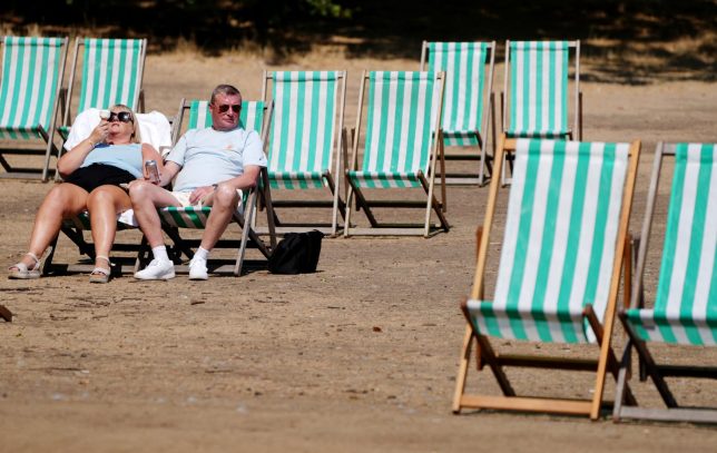 Visitors to Hyde Park, London, make use of rentable deck chairs. Much of England is under an amber warning for extreme heat, in the face of the fifth heatwave in a summer which has also been marked by extremely dry weather and drought for much of England and Wales. Picture date: Friday August 14, 2026. PA Photo. Photo credit should read: Jonathan Brady/PA Wire