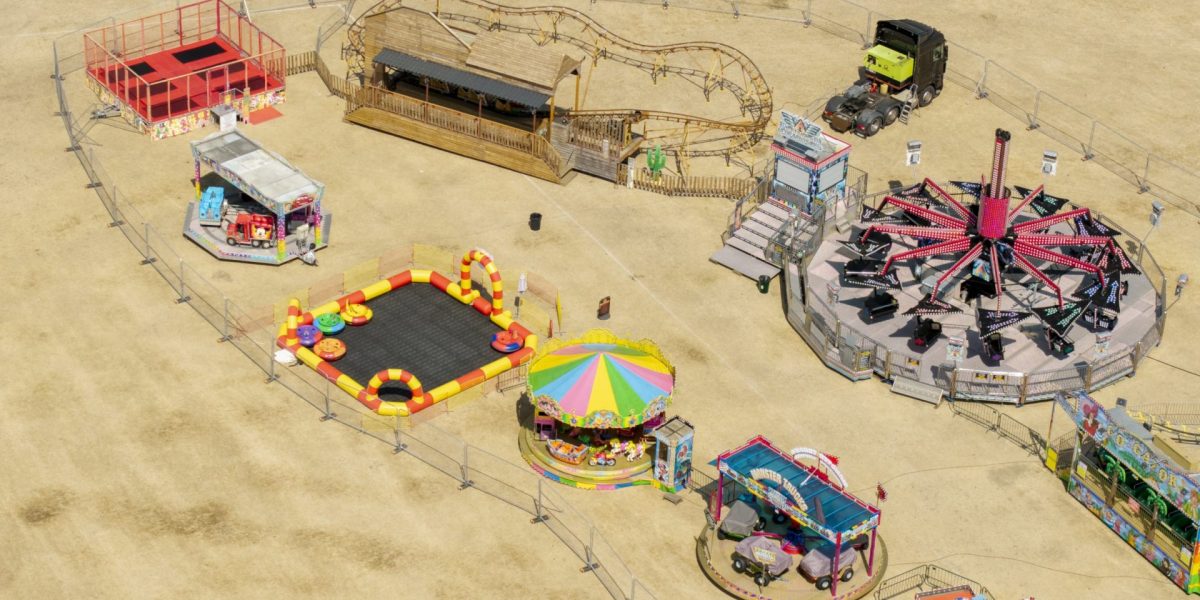 LONDON, ENGLAND ??? AUGUST 14: An aerial view of a funfair is seen before opening on the parched Commonside West in Mitcham, London, on August 14, 2026 in London, England. The UK Health Security Agency (UKHSA) has issued a heat-health alert from Tuesday to Friday for nine regions in England, as parts of the country are forecast to see temperatures in excess of 36C during the fifth heatwave of the season. The National Drought Group has declared that two-thirds of England is now officially in drought, with water use restrictions impacting 27 million people. Last month was the driest July recorded in England and Wales since records began in 1836. (Photo by Brook Mitchell/Getty Images)