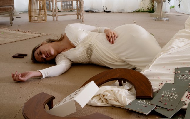 Dawn in her wedding dress lies unconscious on the floor of the marquee in Emmerdale