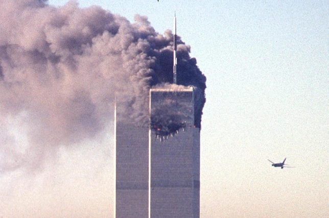 (FILES) In this file photo commercial aircraft United Airlines flight 175 approaches the south tower of the World Trade Center as smoke billows from the north tower in lower Manhattan, New York on September 11, 2001. When 17-year-old student Max Avena visited the site of New York's fallen Twin Towers, hearing the first-hand accounts of survivors of the deadliest attacks on US soil left him "speechless." (Photo by SETH MCALLISTER / AFP via Getty Images)