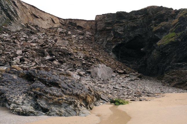 Holy Well Cliff Fall / Rock Fall A major Cliff Fall / Rock Fall on Hoywell Bay Beach has fallen on the site of St Cuthbert's Holy Well Cave. The Cave is now gone buried in thousands of tons of rock. The famous Holy Well formed from cascading, mineral-rich calcareous basins, terraces, and flowstone steps.