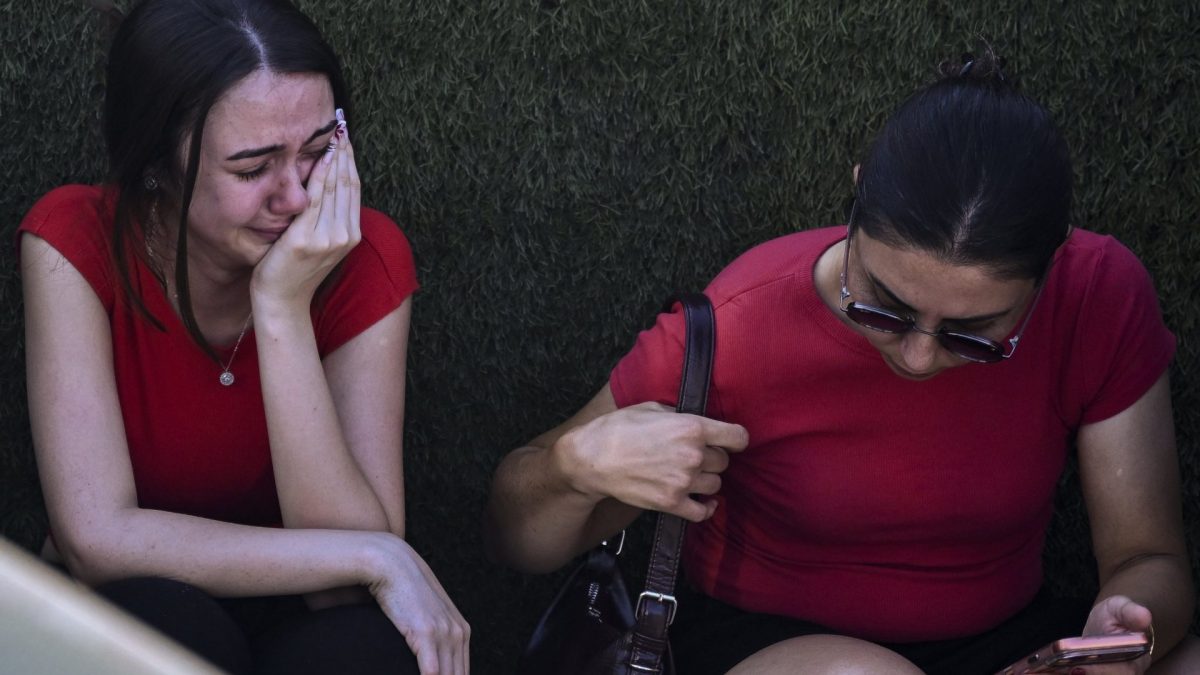 People react as they await news of their loved ones outside the port in Kyrenia, in the self-proclaimed Turkish Republic of Northern Cyprus (TRNC), recognised only by Turkey, on August 30, 2026, after a ferry capsized off the coast. A passenger ferry capsized and sank off Northern Cyprus on August 30, killing at least seven people and leaving 23 missing, officials said, as a rescue operation was under way. (Photo by Jewel SAMAD / AFP via Getty Images)