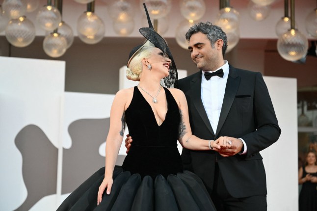 (FILES) Actress and singer Lady Gaga and Michael Polansky attend the red carpet of the movie 'Joker : Folie a deux' presented in competition during the 81st International Venice Film Festival at Venice Lido, on September 4, 2024. Pop superstar Lady Gaga welcomed her first child with fiance Michael Polansky, US media reported on September 11. The 40-year-old "Bad Romance" singer, whose real name is Stefani Germanotta, began dating Polansky in 2020, and became engaged to the entrepreneur in 2024. A source confirmed news of the child's birth to Page Six and People, but no additional details about the baby, including its name, sex or date of birth, were immediately available. (Photo by Alberto PIZZOLI / AFP via Getty Images)