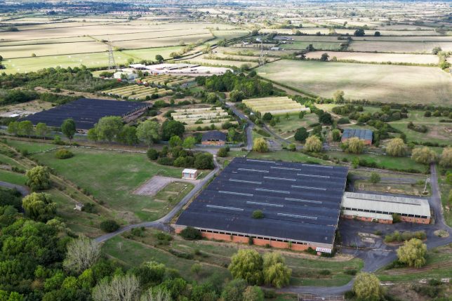 This aerial image shows a former military base where the government has proposed housing some 1,200 asylum seekers in Bicester, near Piddington, Oxfordshire, north-west of London on September 15, 2026, as Piddington, a town of fewer than 400 inhabitants, votes on a symbolic referendum on leaving the UK. Picturesque Piddington village, 25 kilometres (15 miles) from the university city of Oxford, that doesn't have a single shop has found itself on the front line of a national debate about where to locate migrant accommodation. (Photo by JUSTIN TALLIS / AFP via Getty Images)
