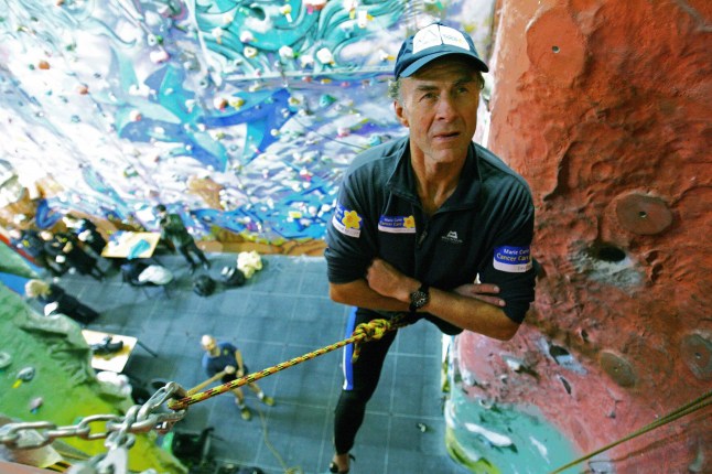 London, UNITED KINGDOM: British Explorer, Sir Ranulph Fiennes, aged 62, scales a climbing wall during a press conference in East London, 26 February 2007. Fiennes will attempt to climb the north face of the Eiger Mountain in the Swiss Alps in March 2007 to raise money for the Marie Curie charity which cares for terminally ill patients. Fiennes suffers from vertigo, a heart condition and has lost fingers from his left hand to frost bite. AFP PHOTO/CARL DE SOUZA (Photo credit should read CARL DE SOUZA/AFP via Getty Images)