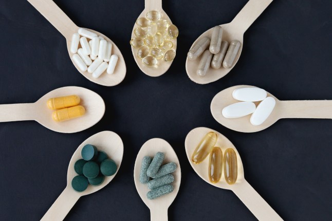 Colourful Organic Pills and Capsules For Women's Health and Fertility Support. Nutritional Supplement At Dark Grey Background. Healthcare and Alternative Medicine, Immune System and Recovering, Sustainable Lifestyle
