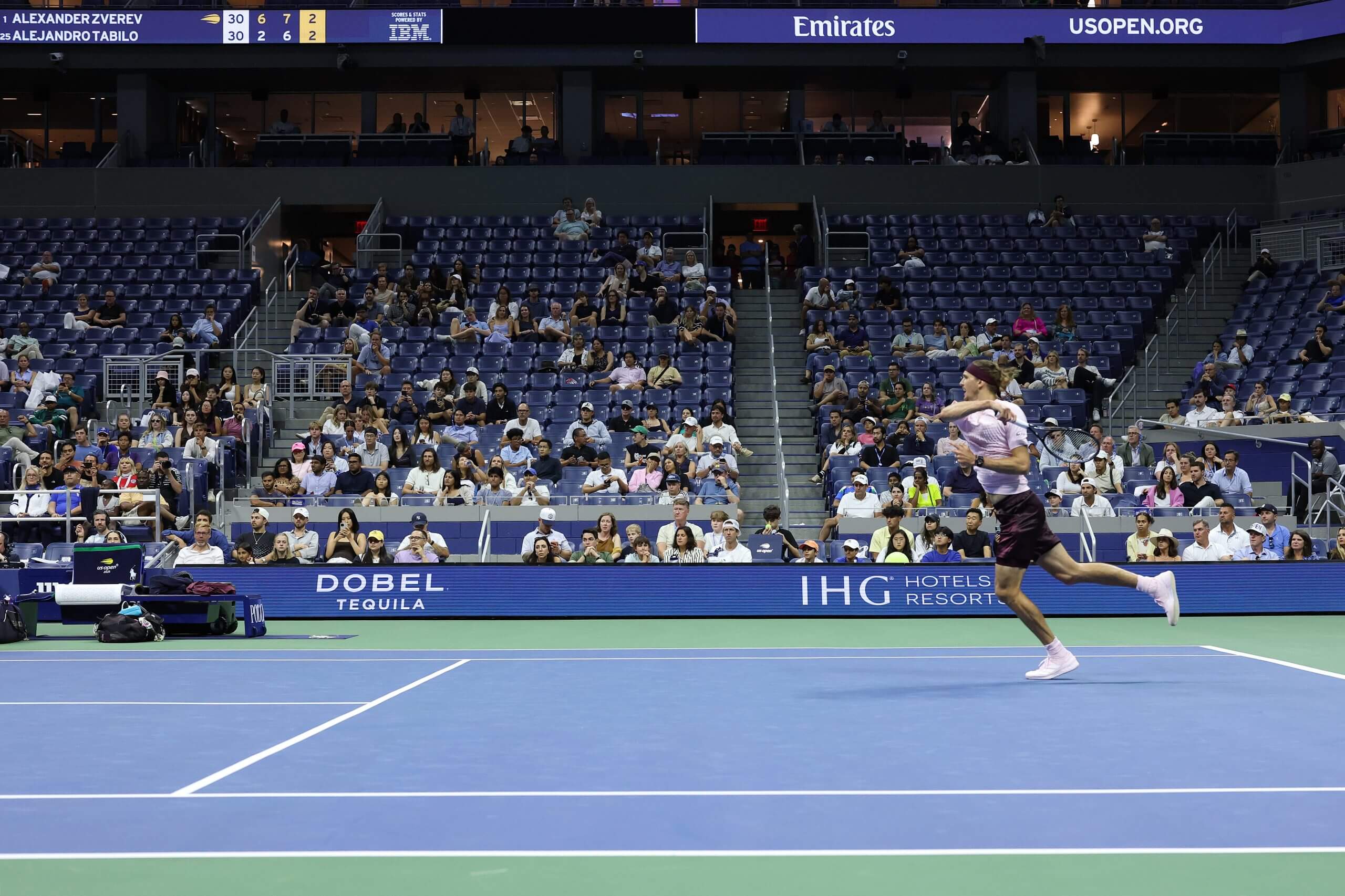 Alexander Zverev hits a forehand in front of sparse crowds.