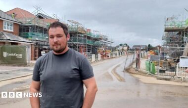 Nathan Long stands in a street of partly built homes