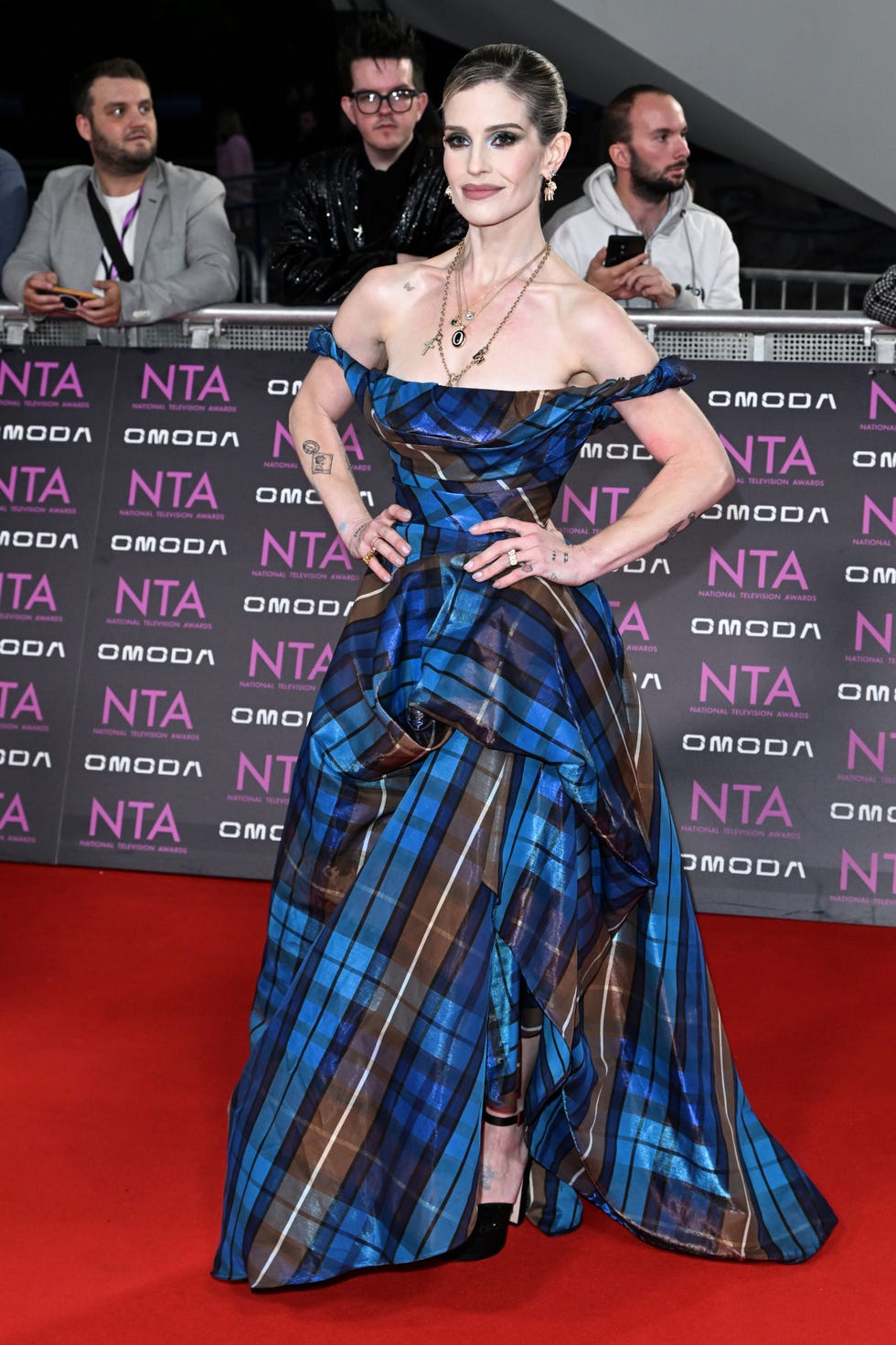 Kelly Osbourne arriving at the 2026 NTA awards kelly osbourne in a blue plaid strapless dress at the 2026 nta awards