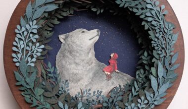 a paper collage on a round surface featuring a wreath-like arrangement of foliage around a large wolf and a young girl in a red cloak