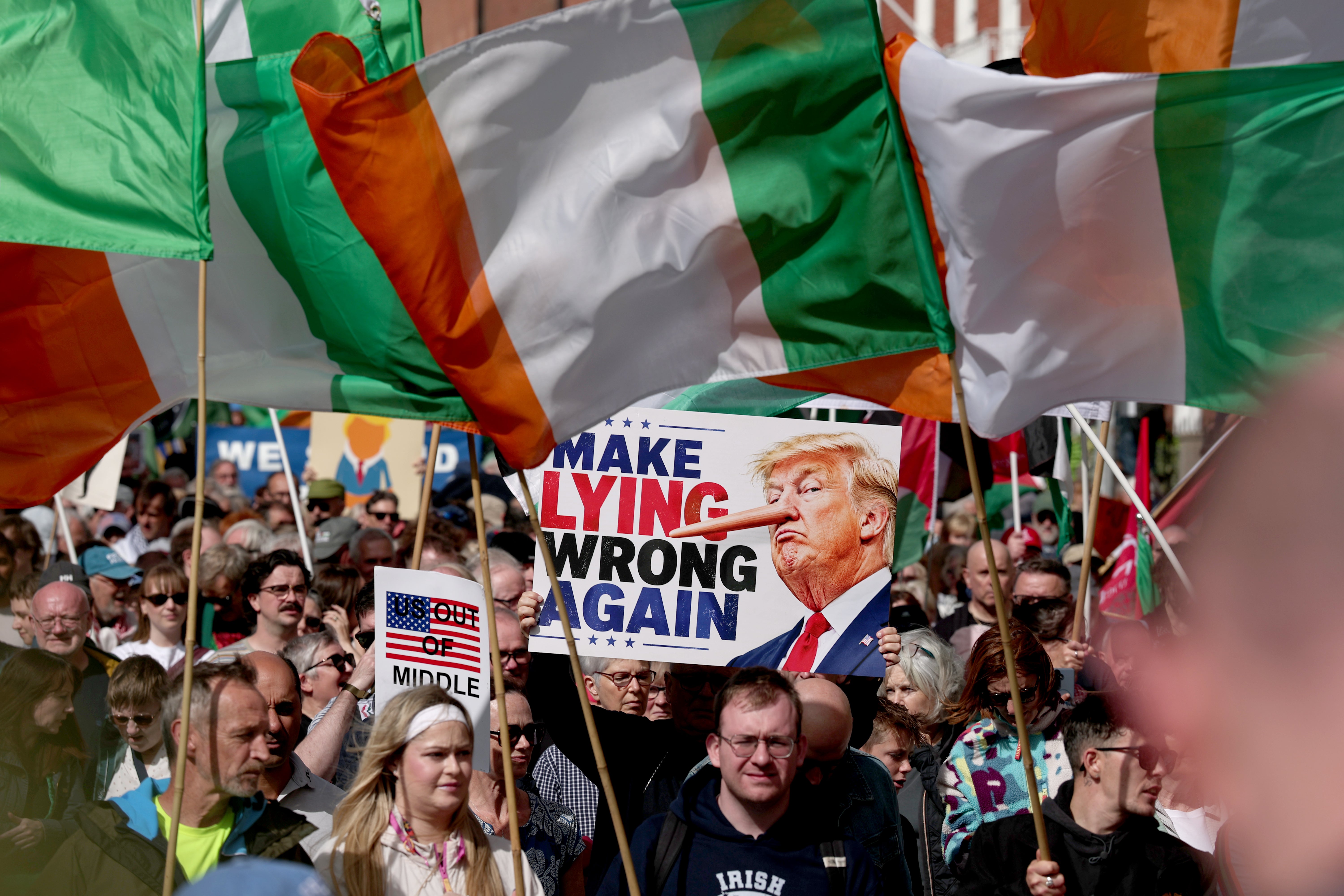 People take part in an anti-Trump protest march through Dublin city (Clodagh Kilcoyne/PA)