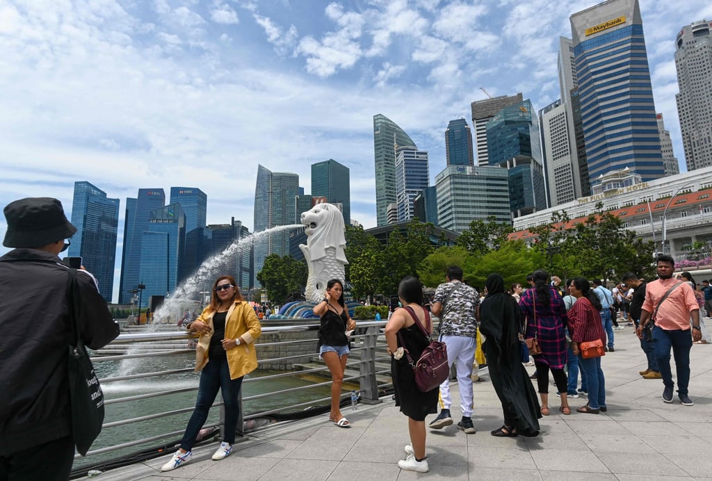 People gather next to the Merlion statue at the Marina Bay waterfront in Singapore. Photo: AFP