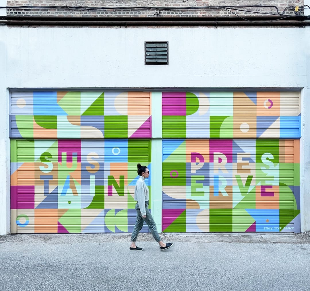 a colorful, abstract mural on a pair of garage doors by Emmy Star Brown, with the words