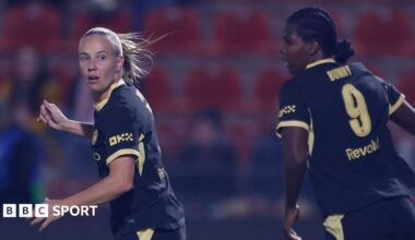 Beth Mead and Khadija Shaw in action for Manchester City, wearing black kit with yellow trim