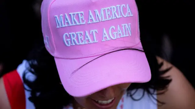 Woman wears pink "Make America Great Again" hat