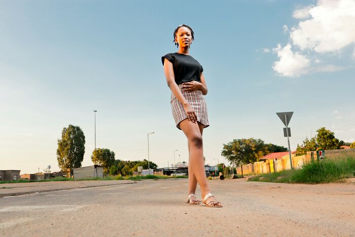 A young woman posing outdoors, representing themes in historical medical practices