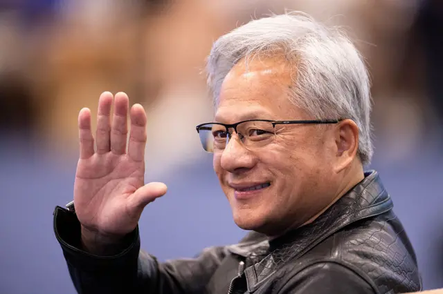 White-haired Huang in glasses and black leather jacket waves hand