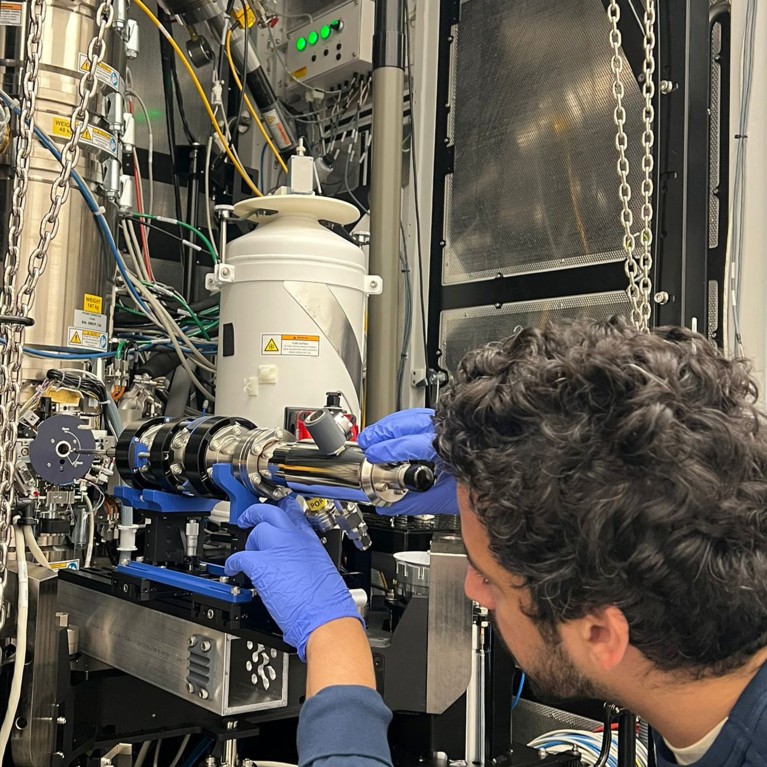 A researcher aligns the h-Bar Instruments liquid helium stage before insertion into an aberration-corrected transmission electron microscope.