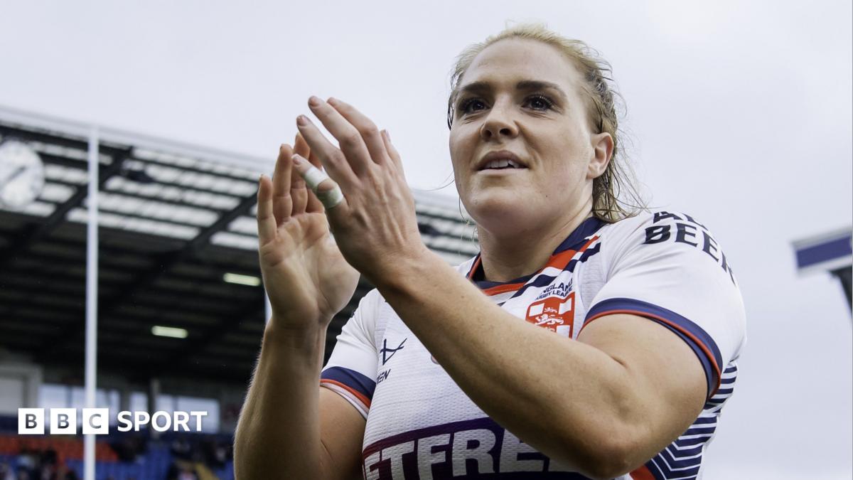 Amy Hardcastle in an England shirt applauding fans