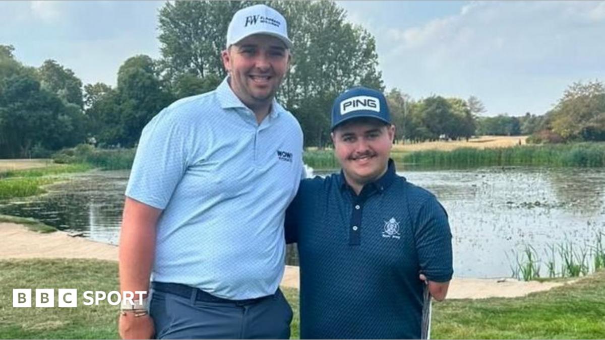 Marcus Armitage is wearing a sky blue polo shirt and a white cap. Adam Dalton Dalton is standing beside him wearing a navy blue cap and a navy blue polo shirt.