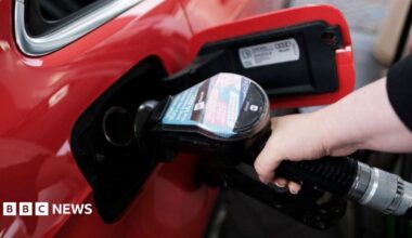 A woman fills a car with diesel from the pump