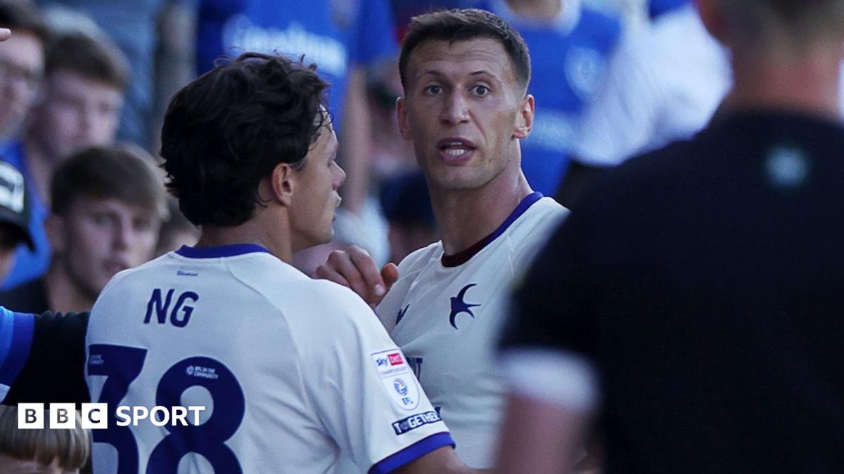 Krystian Bielik and Perry Ng, both in white and blue Cardiff City shirts, react at Portsmouth