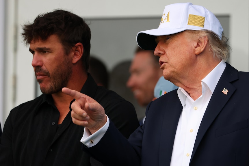 Donald Trump speaks with US pro golfer Brooks Koepka.