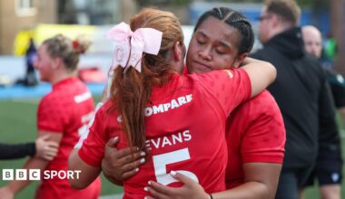 Sisilia Tuipulotu hugging Georgia Evans after defeat by USA