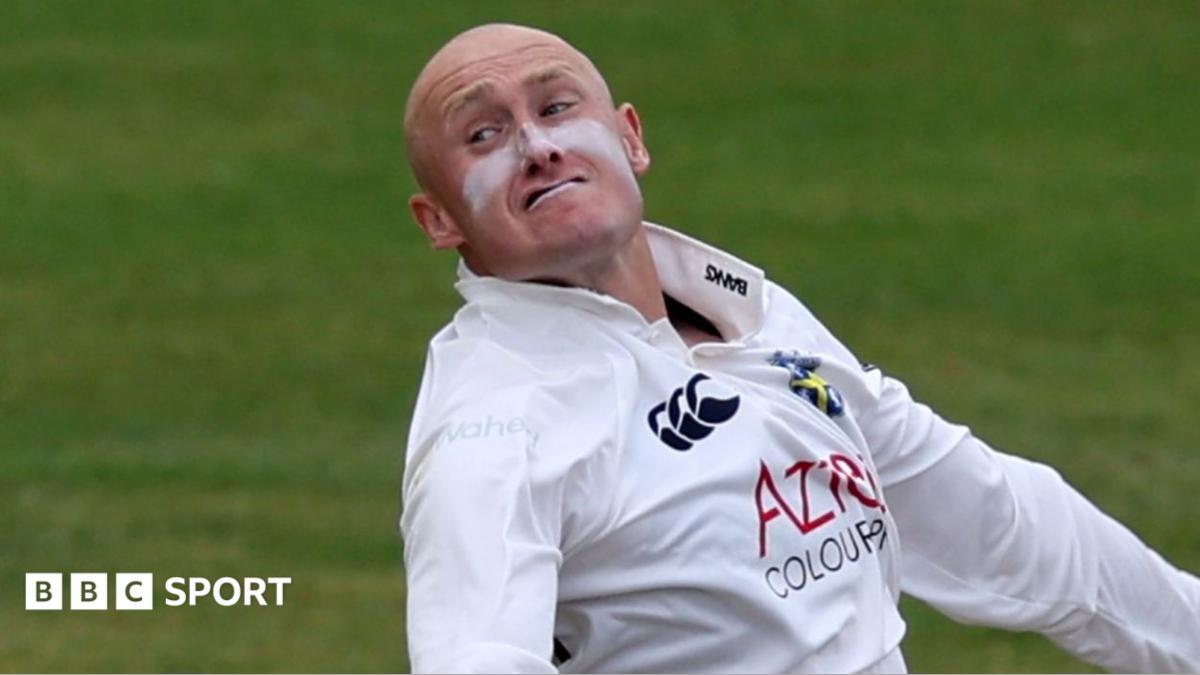 Callum Parkinson bowling with a grimace on his face