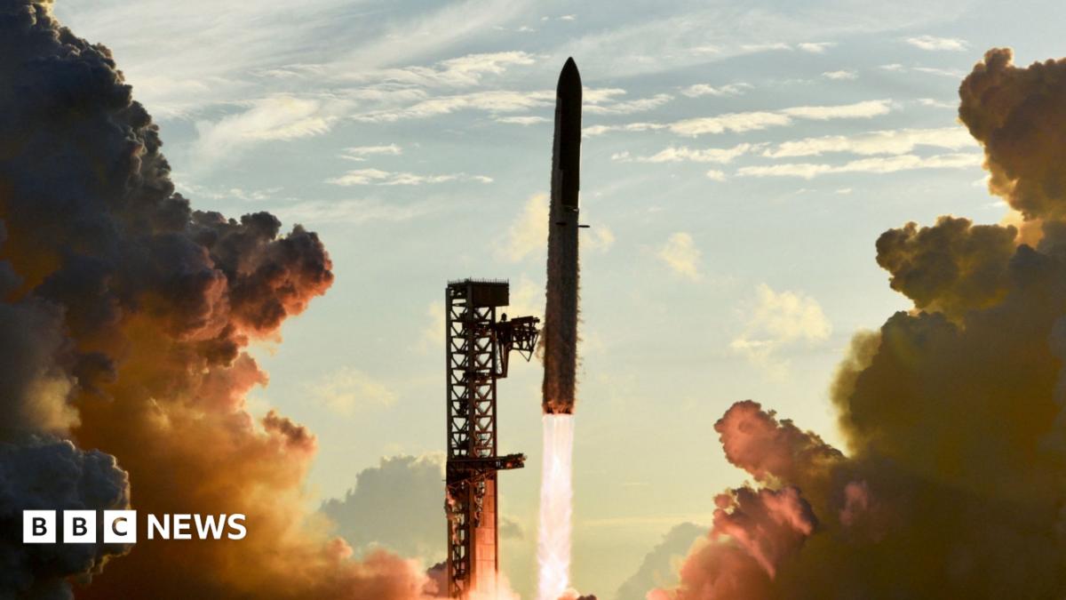 A Space X rocket blasting off from a launch site surrounded by smoke from the exhaust