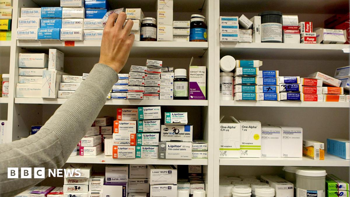 A pharmacist stocking shelves at a chemist.