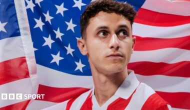 American Luca Bombino poses in front of the star spangled banner