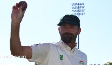 Ian Holland holds up the ball after taking 6-38 against former club Hampshire