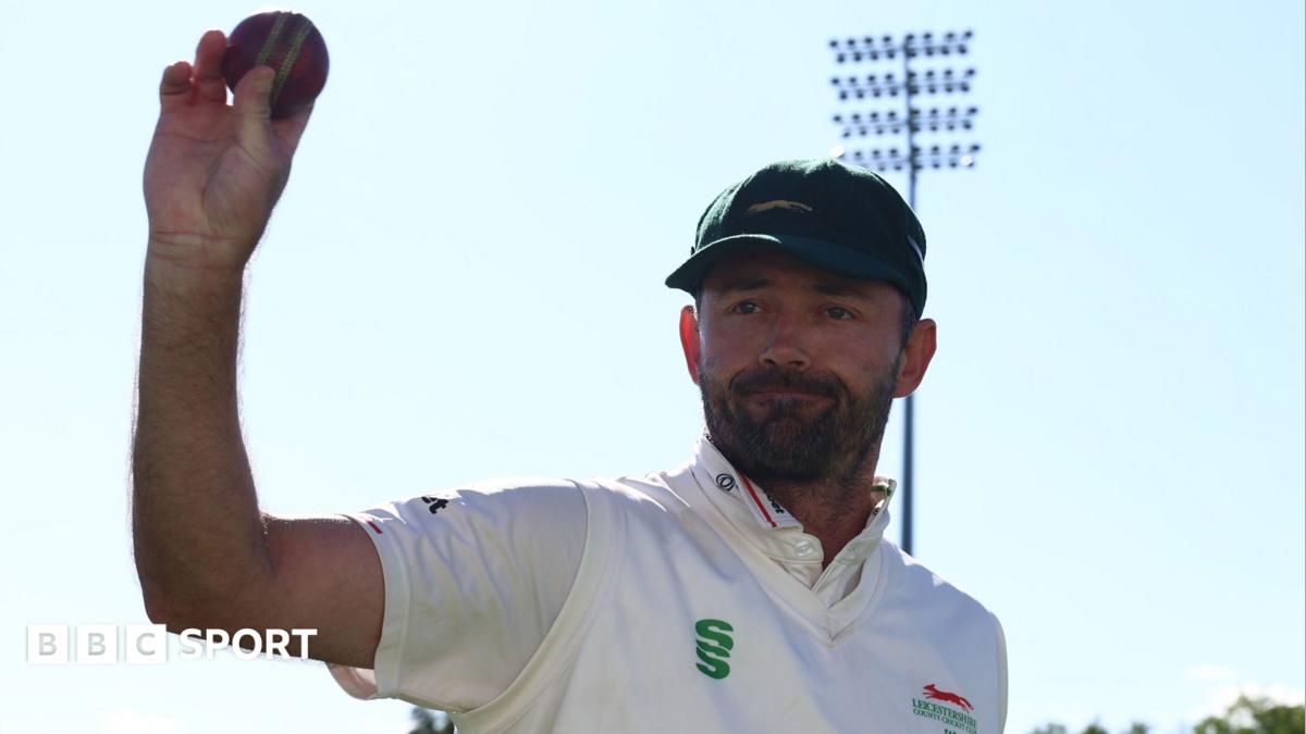 Ian Holland holds up the ball after taking 6-38 against former club Hampshire