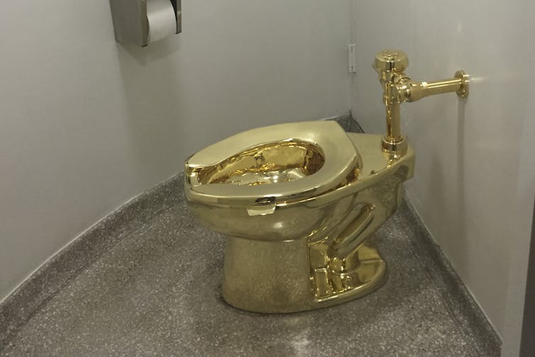 Gold public-bathroom-style toilet in room