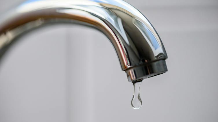 silver tap dripping with water