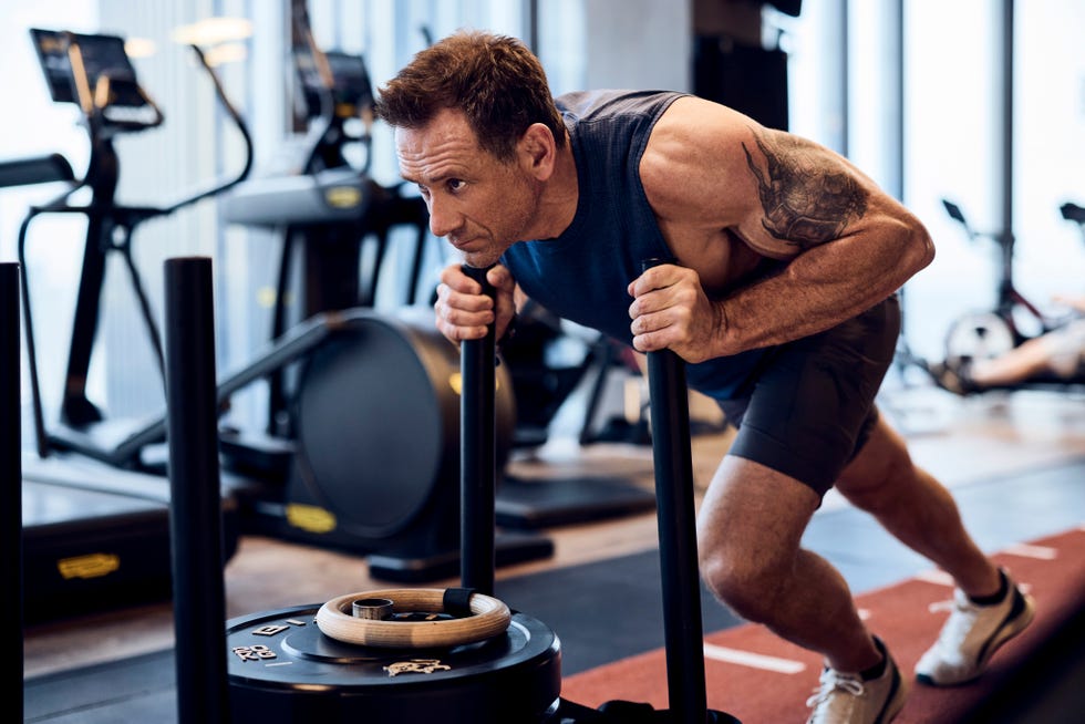 jason fox working out on sled push
