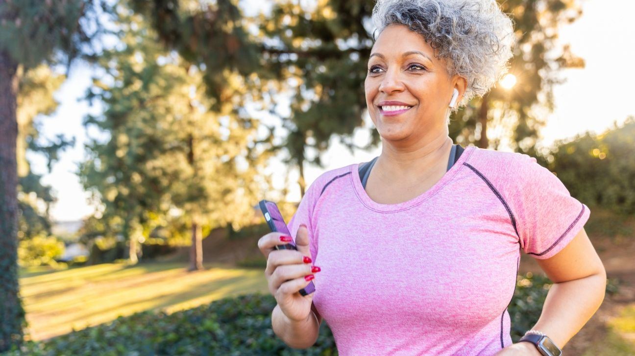 Older female going for a brisk walk outside in a park