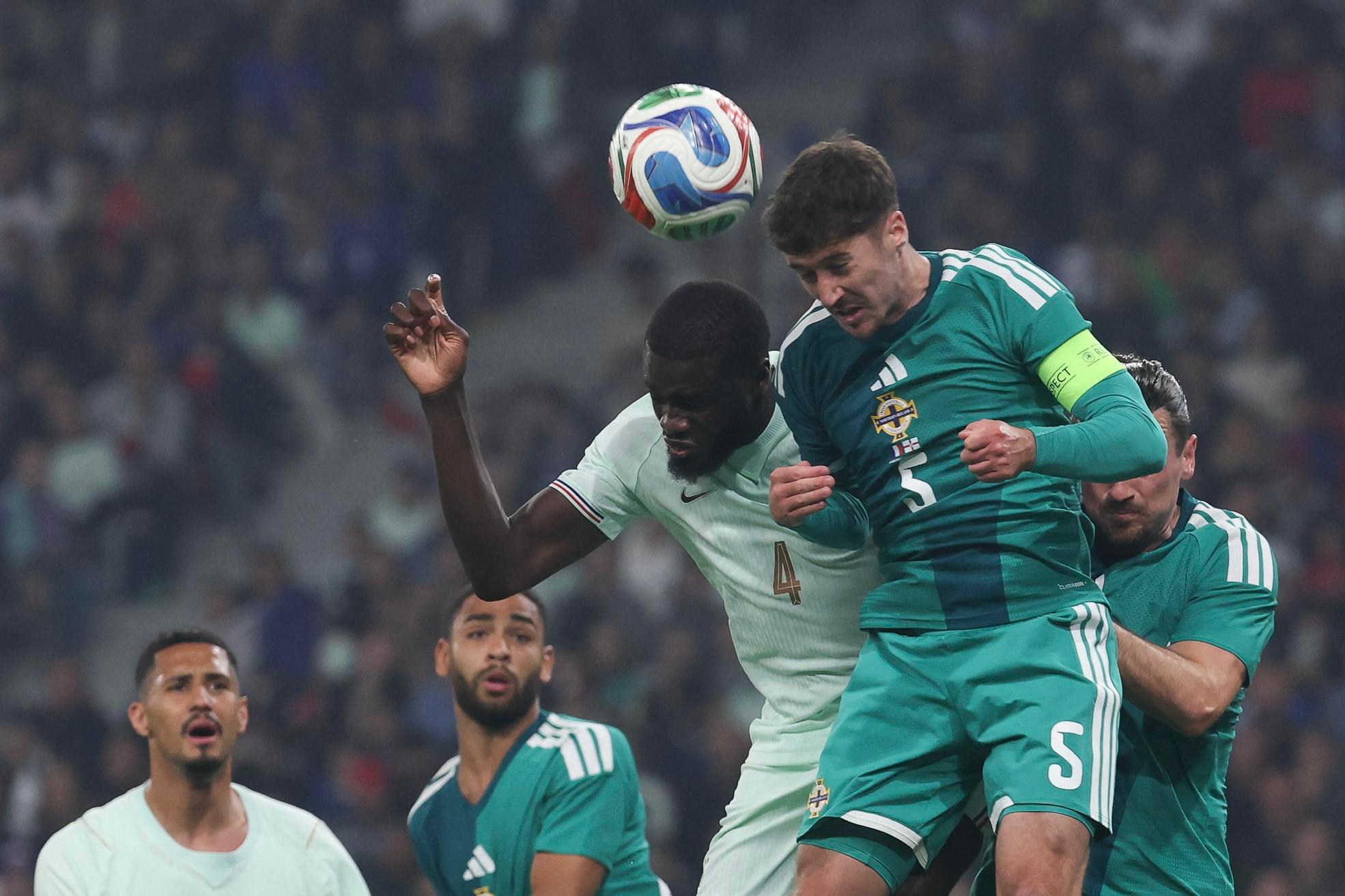 France’s defender #04 Dayot Upamecano (C) and Northern Ireland’s defender #05 Trai Hume (R) jumps for the ball during the international friendly football match between France and Northern Ireland at the Pierre-Mauroy stadium in Villeneuve-d’Ascq, northern France on June 8, 2026, ahead of the 2026 FIFA World Cup football tournament. (Photo by FRANCK FIFE / AFP via Getty Images)
