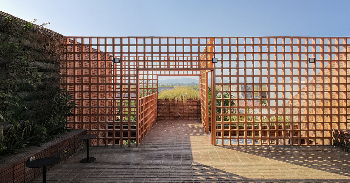 stone and terracotta layer across three-story gathering space in indonesia
