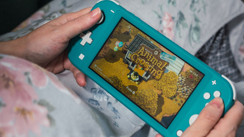 woman playing animal crossing on Nintendo Switch Lite