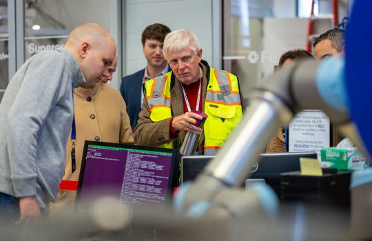 Fermilab Director Norbert Holtkamp talks with employees inside ICB — the Industrial Center Building — on the Fermilab campus. Credit: JJ Starr, Fermilab