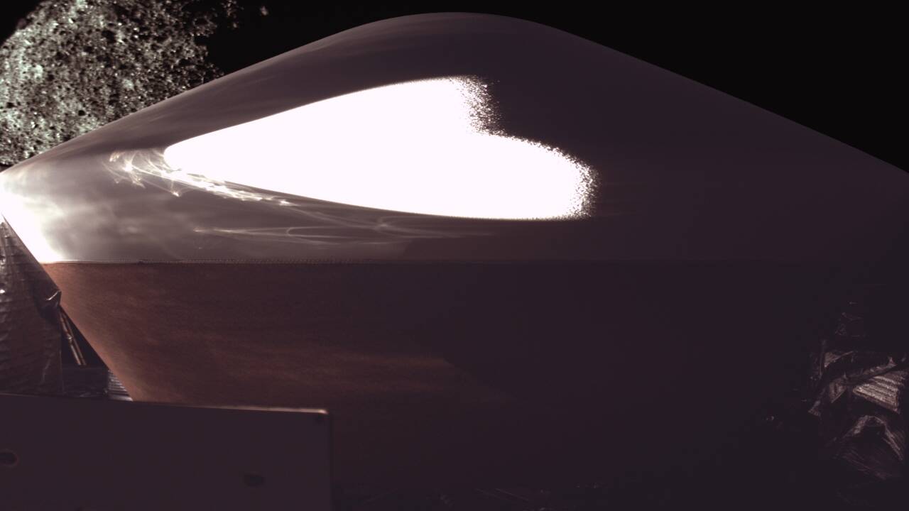 Image of OSIRIS-REX's sample return capsule (SRC) with asteroid Bennu in the background. Credits - Wikimedia Commons OSIRIS-REX's sample capsule (SRC) with asteroid Bennu<br>