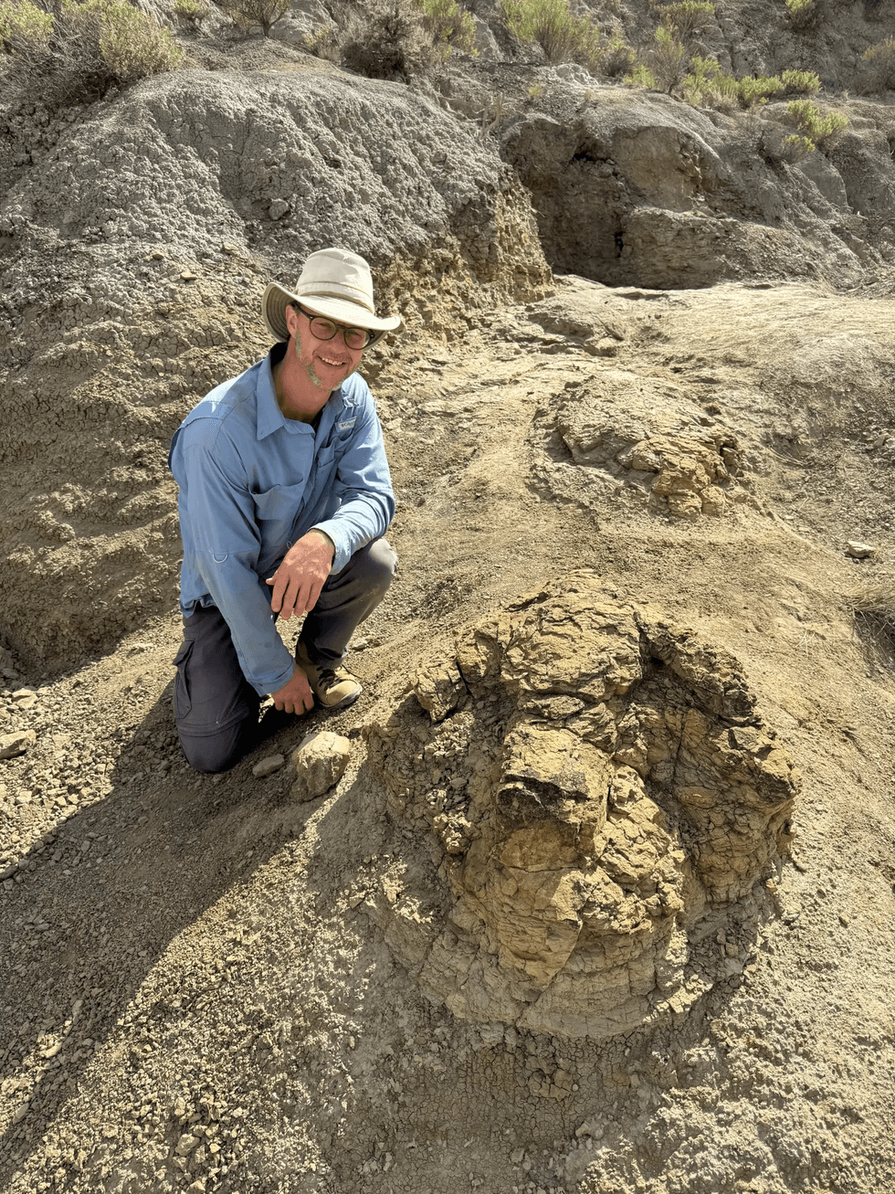 Palaeontologist Tyler Lyson poses with a T-Rex prints